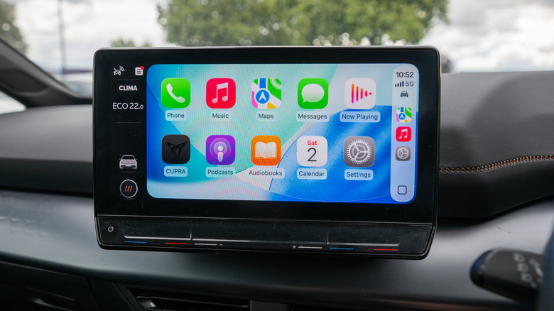 A vehicle's infotainment screen displaying the Apple CarPlay Home screen