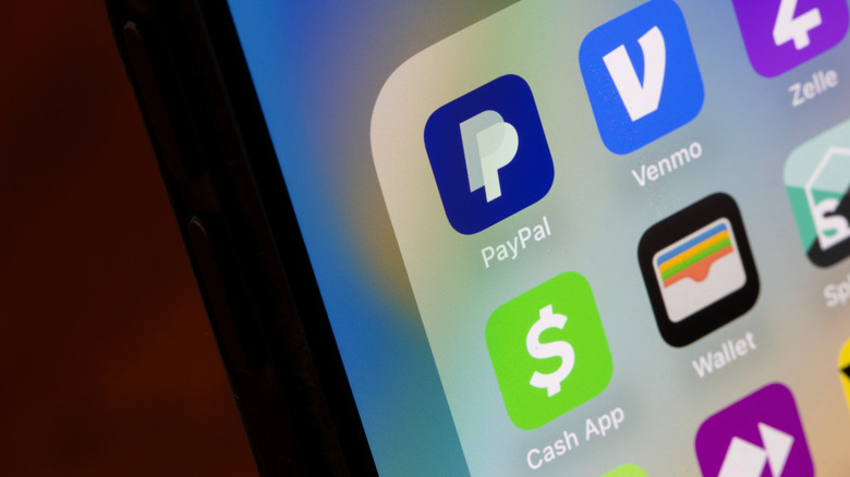 Close up of payment app icons on phone including Cash App, Paypal and Venmo.