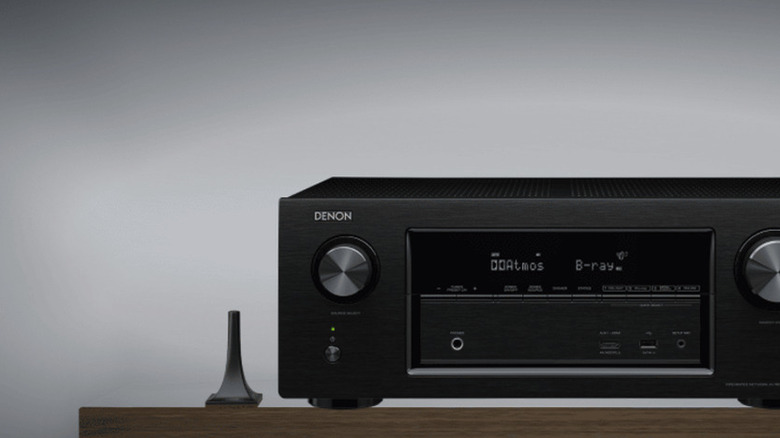 An Audyssey room calibration mic next to a Denon AVR.