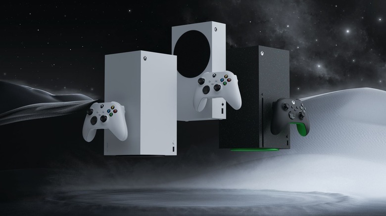 Three Xbox consoles and controllers on a black and gray background.