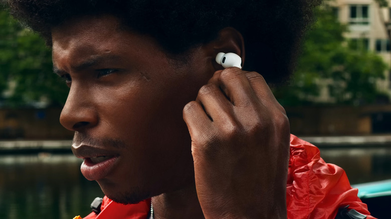 Man putting in AirPods Pro in his ear