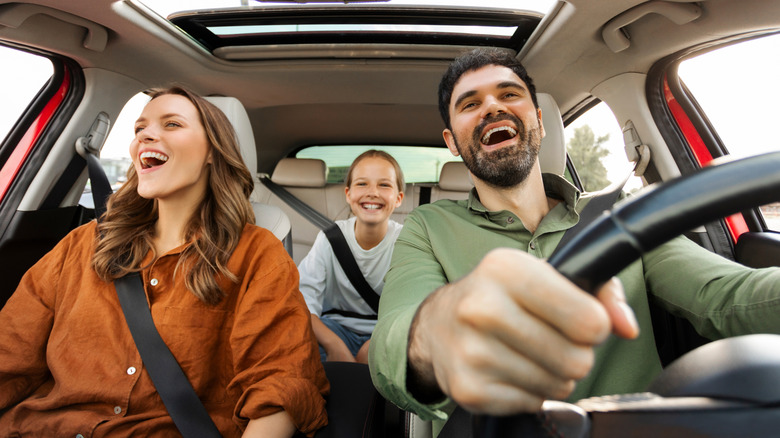 A family driving in a car and listening to music.