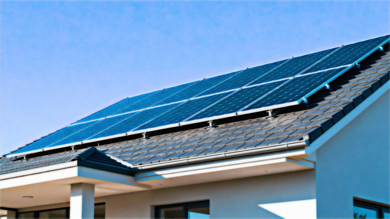 Solar panels on a rooftop facing the sun.