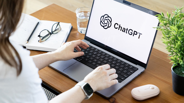 A person using a computer with the ChatGPT logo on the screen.