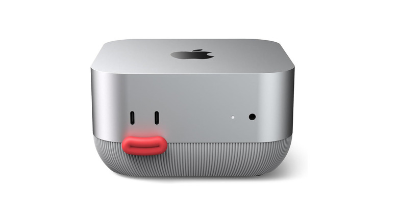 Mac mini with third-party stand featuring red button on white background