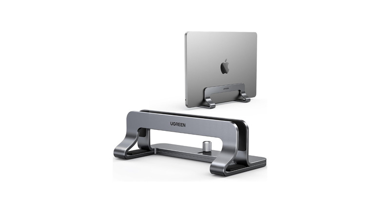 Two silver vertical laptop stands, one empty and the other holding a MacBook