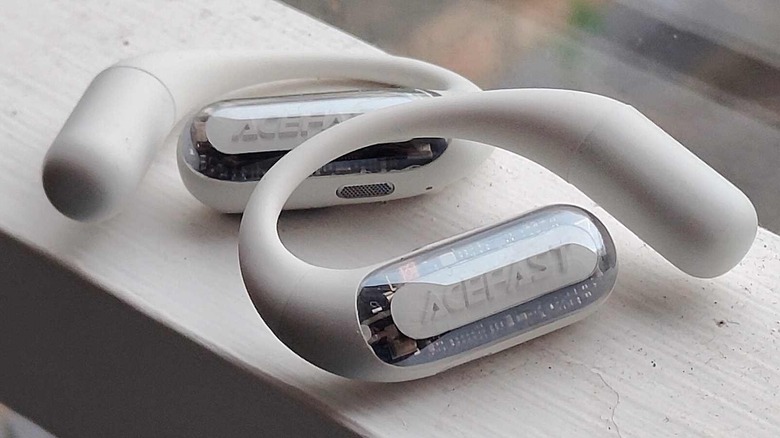 Two AceFast AceFit earbuds on a shelf.