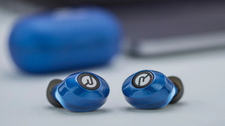 A pair of Raycon earbuds outside of their charging case