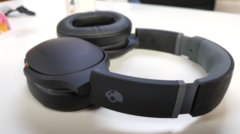 A pair of Skullcandy Crusher Evo headphones on a desk.