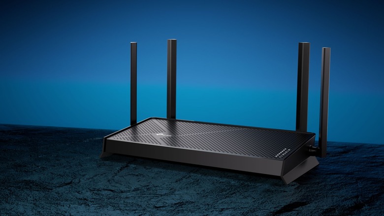 The TP-Link Archer BE3600 router on a table with blue background