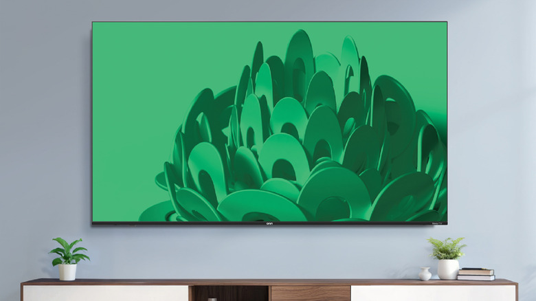 Onn 75-inch 4K TV mounted on a wall.