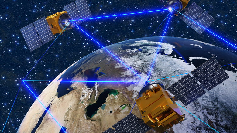 Satellites communicating in space via blue laser transmissions.