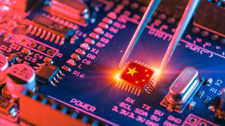 A close-up of a computer motherboard with a chip featuring the Chinese flag, representing technological advancement and manufacturing in China.