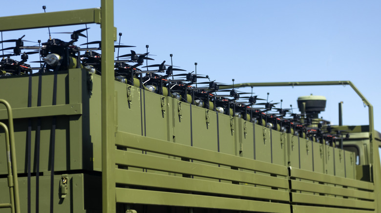 A large group of drones on a truck.