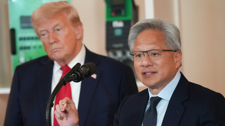 Nvidia CEO Jensen Huang gives a speech with President Donald Trump in the background at a Nvidia event in September 2025.