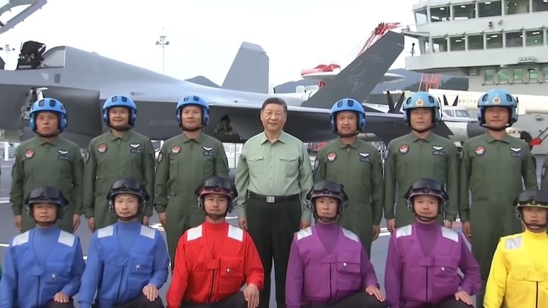 Chinese President Xi Jinping poses with a team of pilots aboard the Fujian during its November commissioning ceremony.