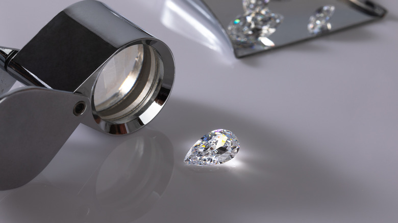 Close-up of jewelers loupe and diamond