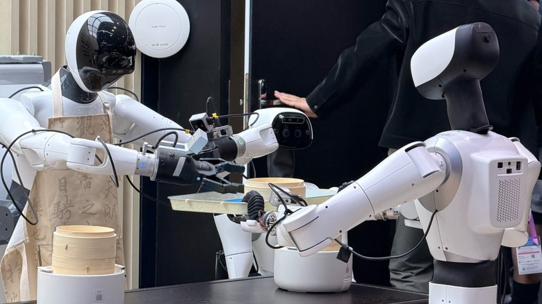Humanoid robots interacting in a restaurant environment at MWC 2026