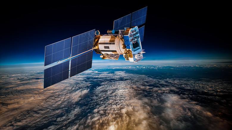 A lone satellite orbiting Earth with the planet visible below.