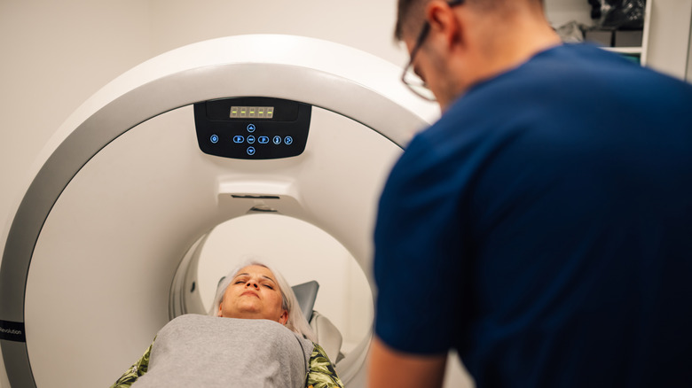 a patient going into a CT scanner