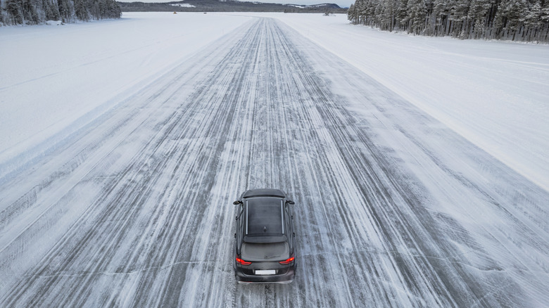 High angle of an EV travelling on a snowy road