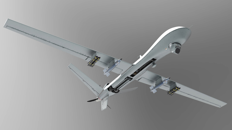 Drone concept on grey background, flying with missiles on bottom of wings