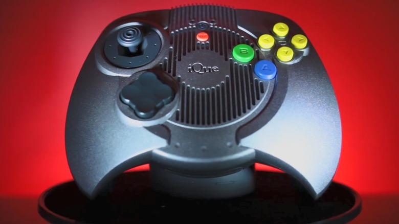 Nintendo iQue Player controller in front of a red background