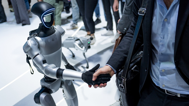 Unitree G1 robot shaking hands with someone