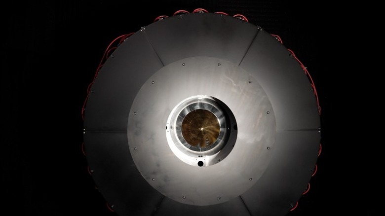 DARPA's optical power beaming receiver is shown against a dark black background.