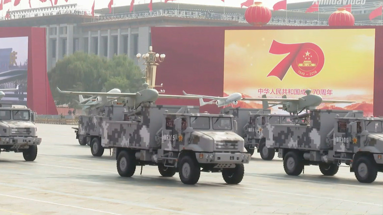 A PLA military parade shows Chinese UAVs mounted on camouflaged truck beds.