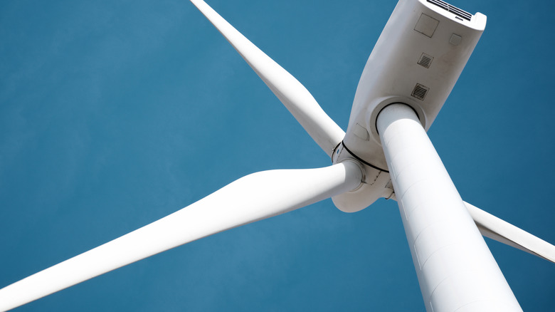 Looking directly up at a wind turbine.