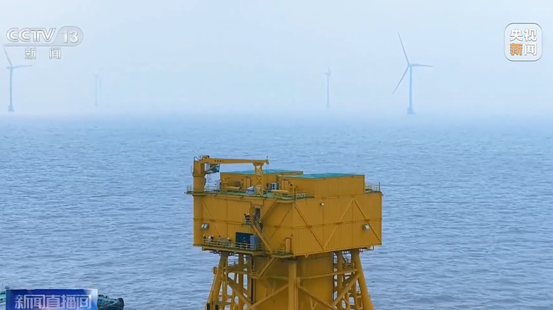 Part of the data center in the ocean surrounded by wind turbines