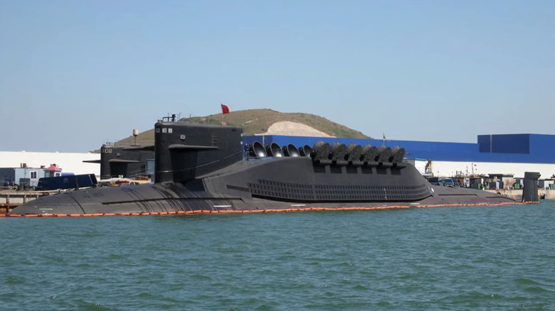 The black hull of China's Type 094 attack submarine stands at port.