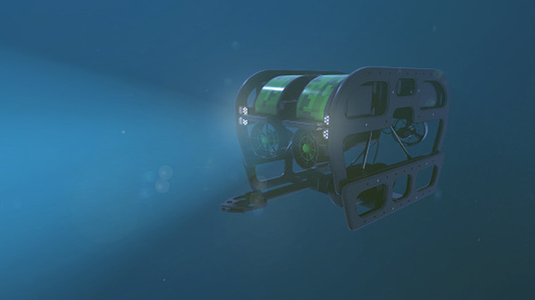 An underwater drone operates in the darkness of the deep sea