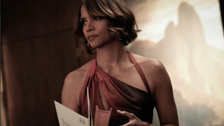 Sharon Combs (Halle Berry), clothed in a flashy red cocktail dress, stares menacingly at an unseen figure in Crime 101
