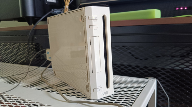 A Nintendo Wii on a grated surface