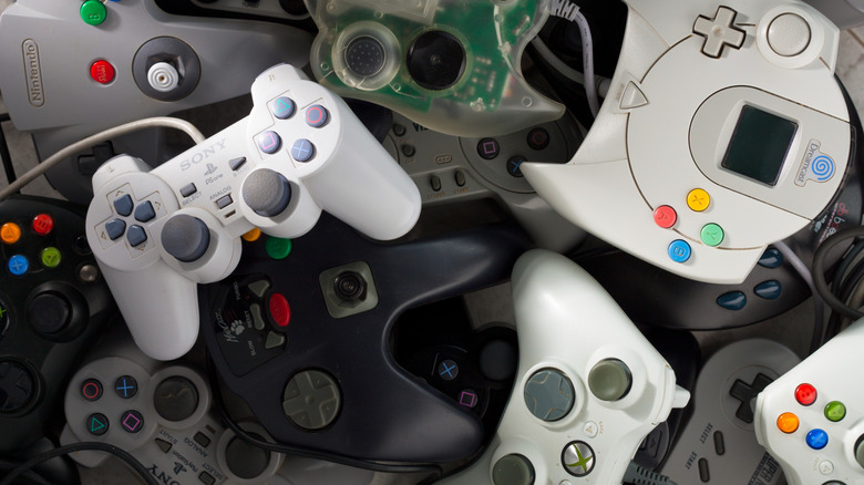 A collection of retro game controllers (PS2, Xbox 360, N64, Dreamcast, etc.)