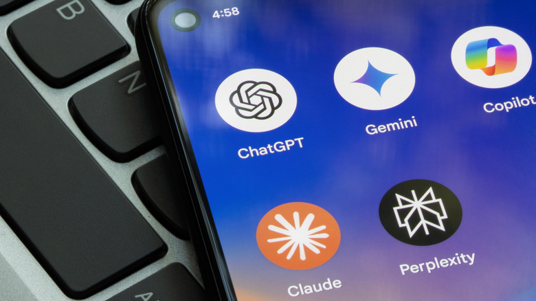 An Android phone with app icons showing on a laptop keyboard