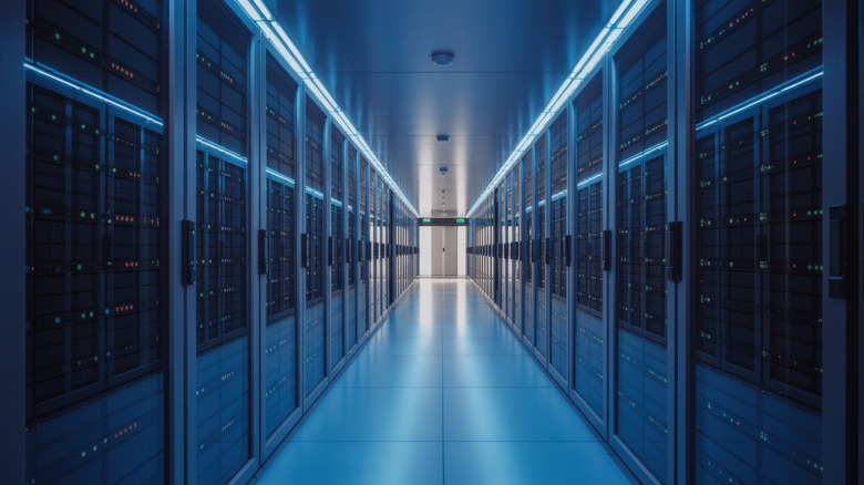 A hallway full of server racks in a data storage center.