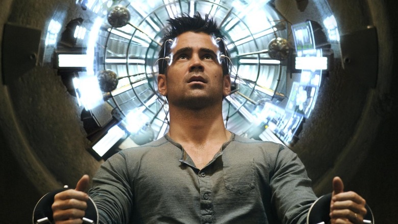 Colin Farrell sat in a chair looking up with things on his head in Total Recall