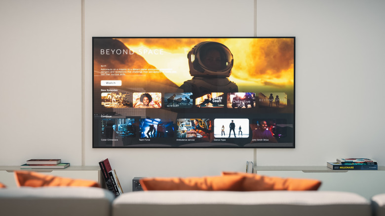 TV displaying a show on a white wall