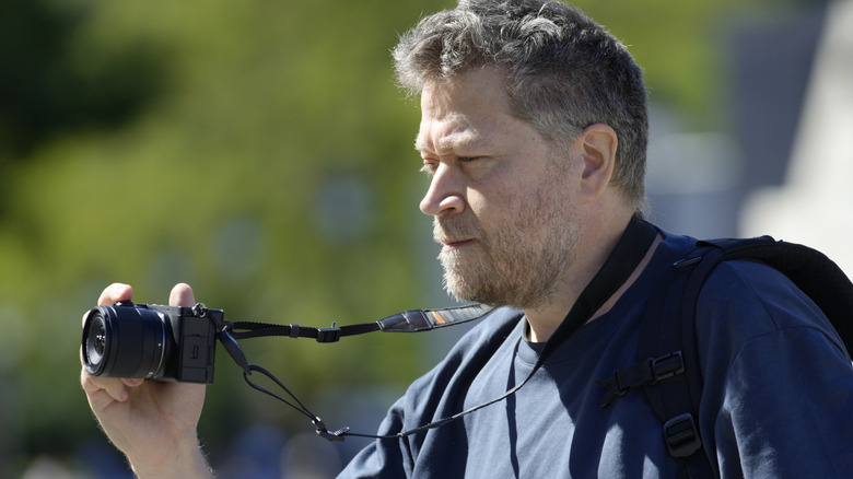 Man holding a mirrorless camera