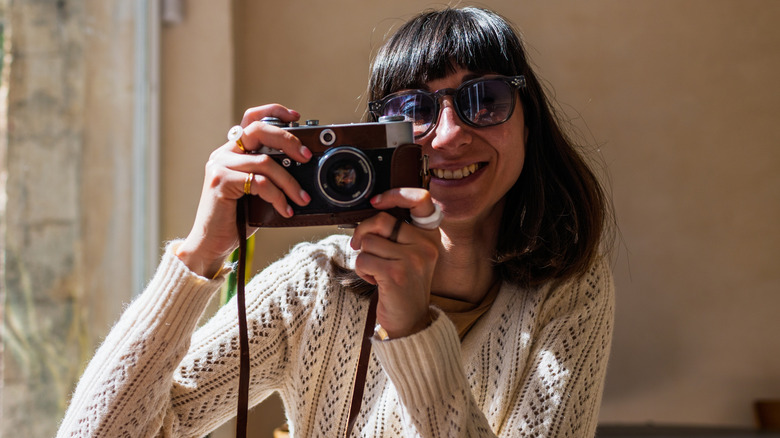 Woman using a small camera