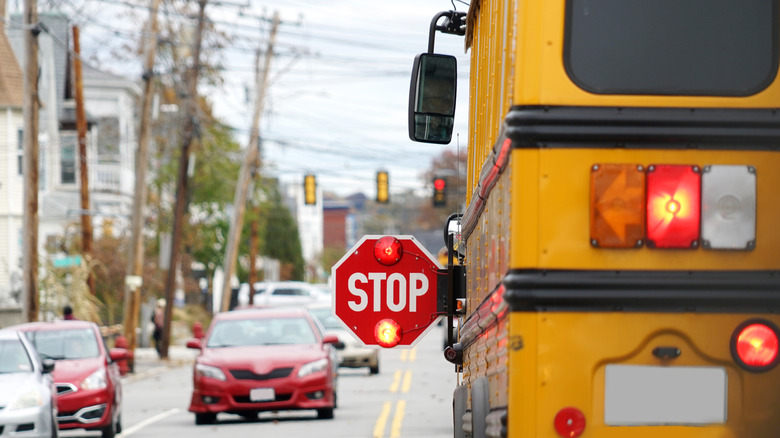 A school bus on the street with stop-arm extended
