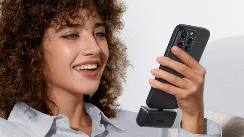The Anker Nano power bank being used by a woman