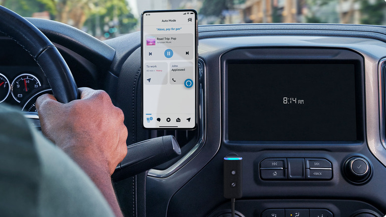Amazon Echo Auto mounted in a car beside the dashboard.