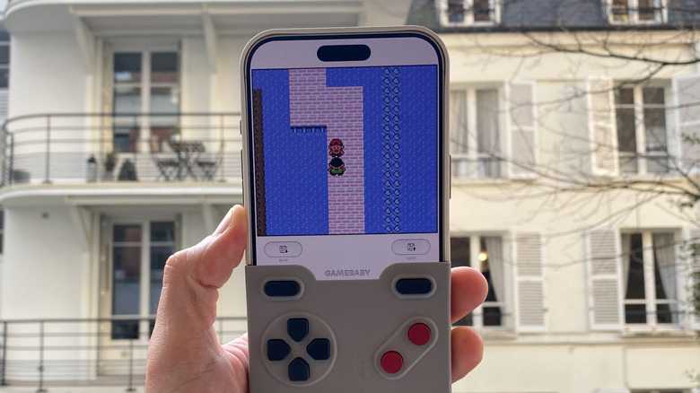 A hand holding an iPhone 17 Pro Max with a case that resembles a Game Boy