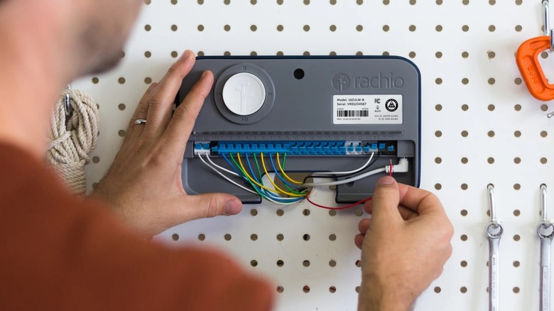 A person installing the Rachio 3 Smart Sprinkler Controller