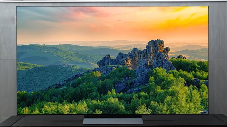 An LG OLED C5 smart television displaying a lush and hill-filled landscape that seems to go on for miles