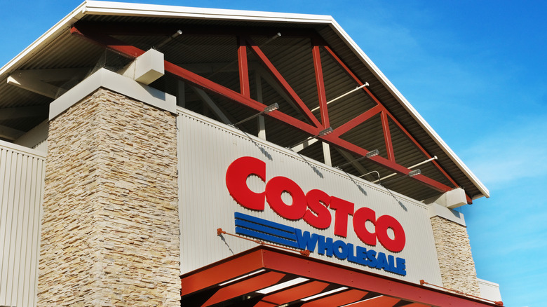 The front sign of a Costco wholesale store with the entrance visible.